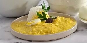 Ají de gallina peruano preparado en Thermomix Ají de gallina cocinándose en el vaso de Thermomix Acompañamiento cocinándose en Varoma para ají de gallina Cocción en niveles con Thermomix Ají de gallina servido con su acompañamiento